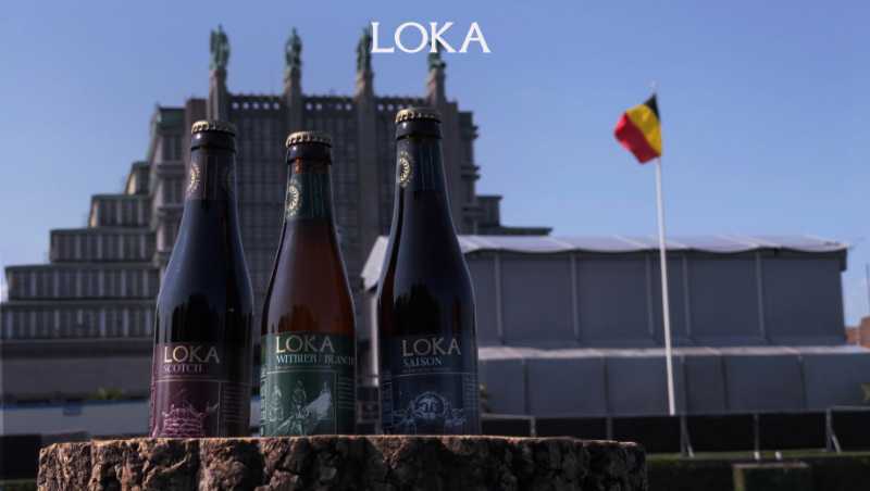 Three Lokabrews beer bottles in front of a building in Belgium